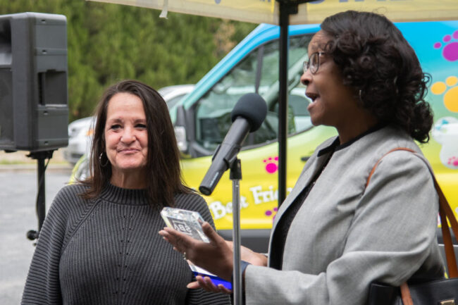 Michelle Harris (right), director of SBA Delaware, presents Lisa St. Clair (left) with the Small Business Person of the Year award. (Source: Tail Bangers)