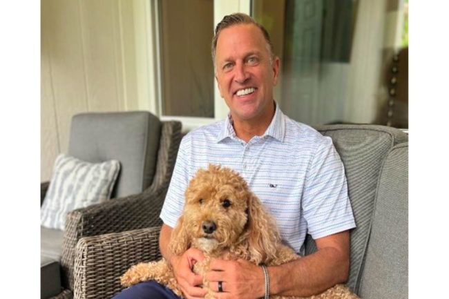 Todd Northcutt, senior vice president of retail store operations at Pet Supermarket, and his dog Izzy
